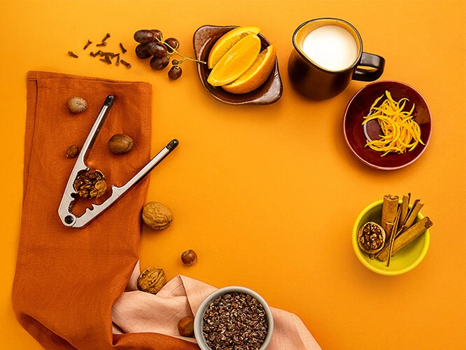 Pantry - pantry items on a table setting, including nuts, grains, spices and fruits.